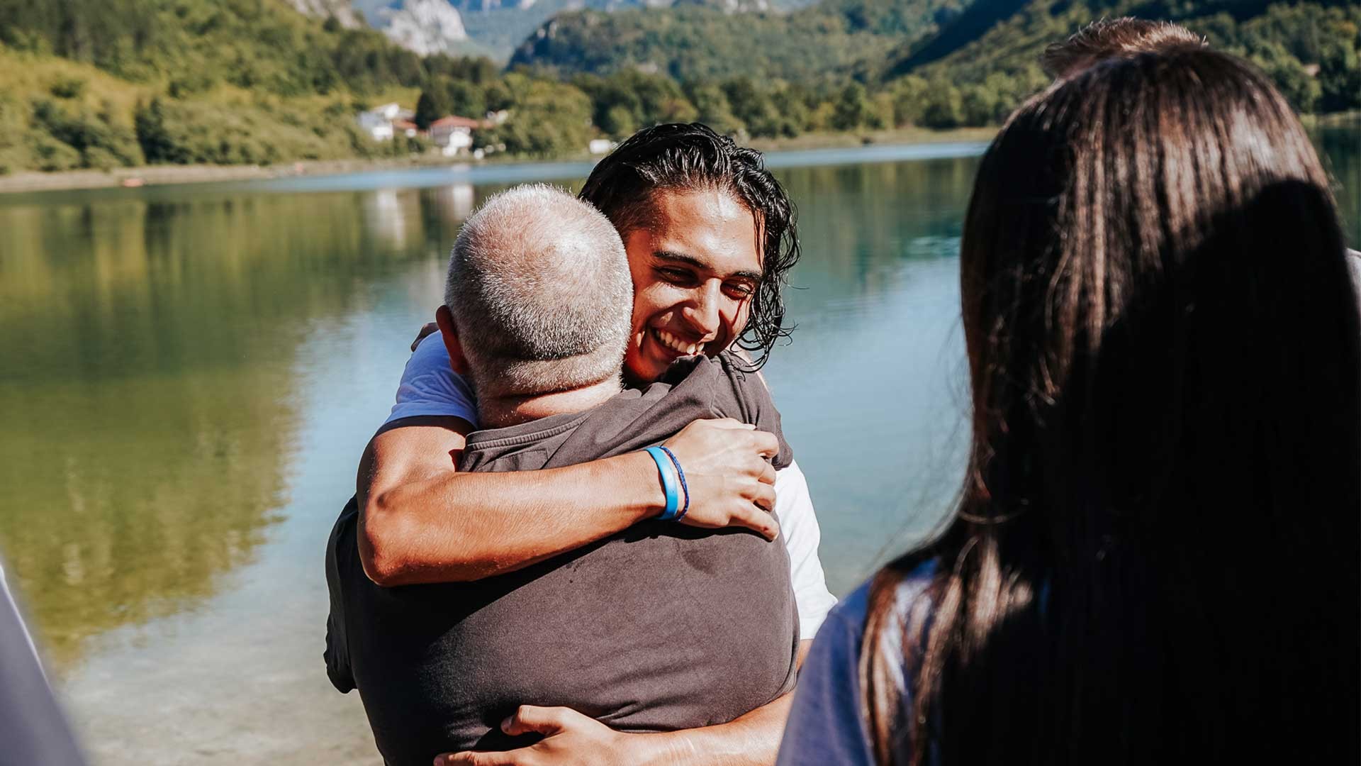 Two people hug after a baptism